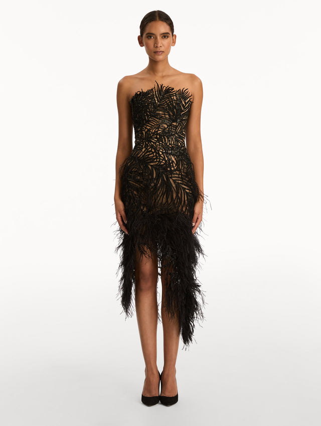 Black Feather Embroidered Cocktail Dress with strapless embroidered bodice, feathered hemline, and asymmetrical skirt. Front View.