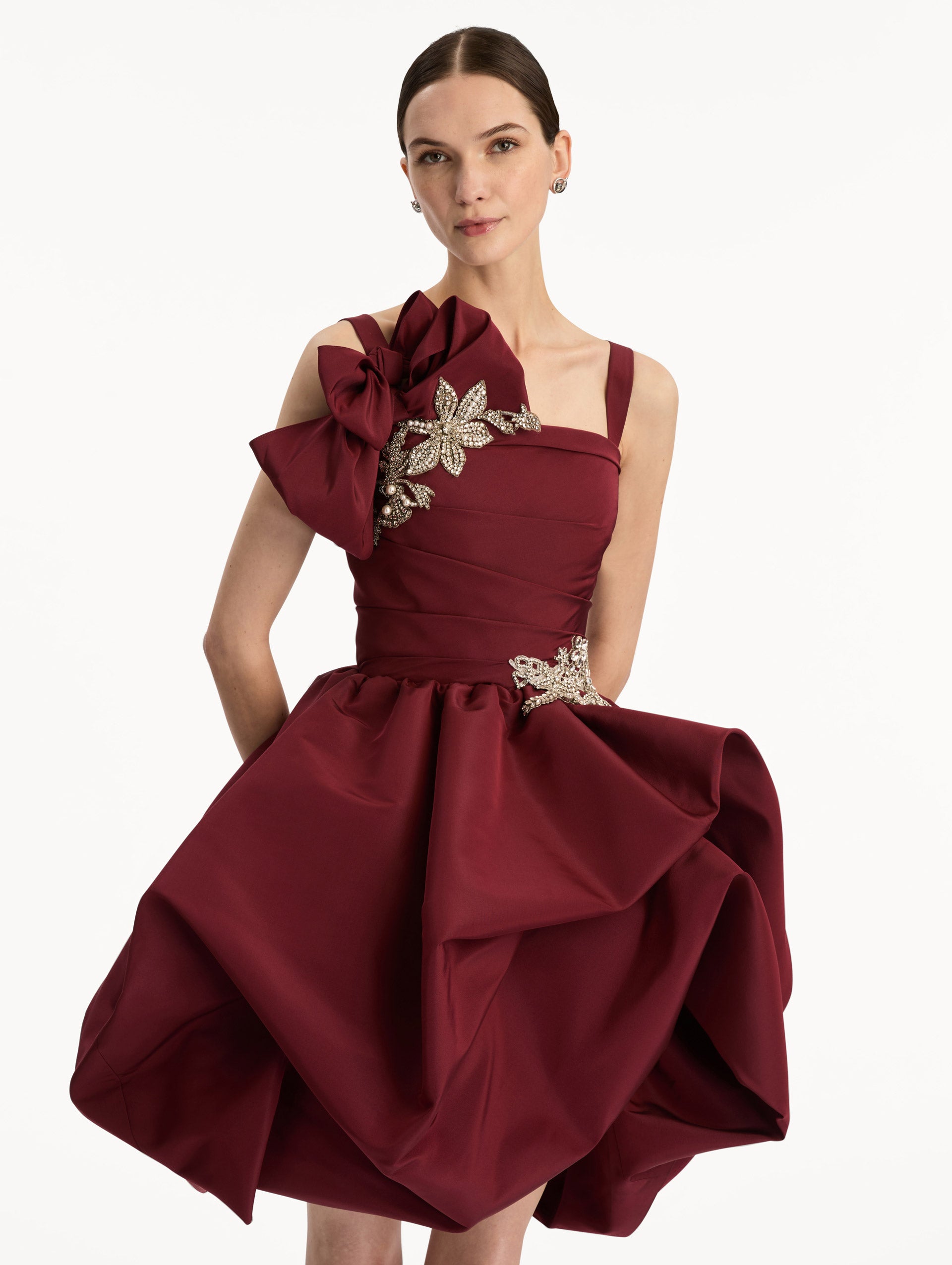 Maroon Brooch Embroidered Cocktail Sleeveless Dress with draped balloon skirt and crystal embroidery on hip and shoulder. Zoom View.