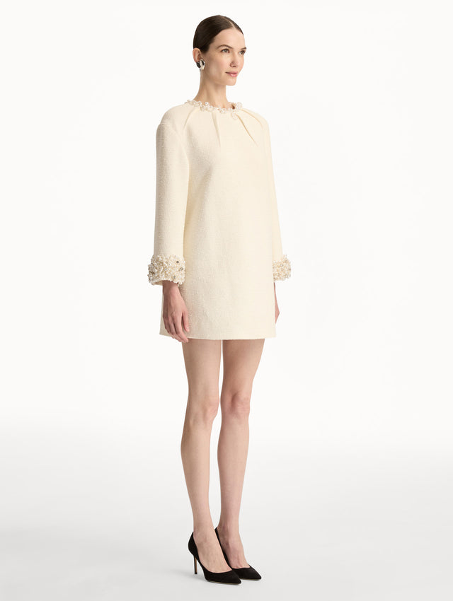 White Pearl Embroidered Tweed Shift Dress featuring embellished sleeves and pleated neckline. Side View. 