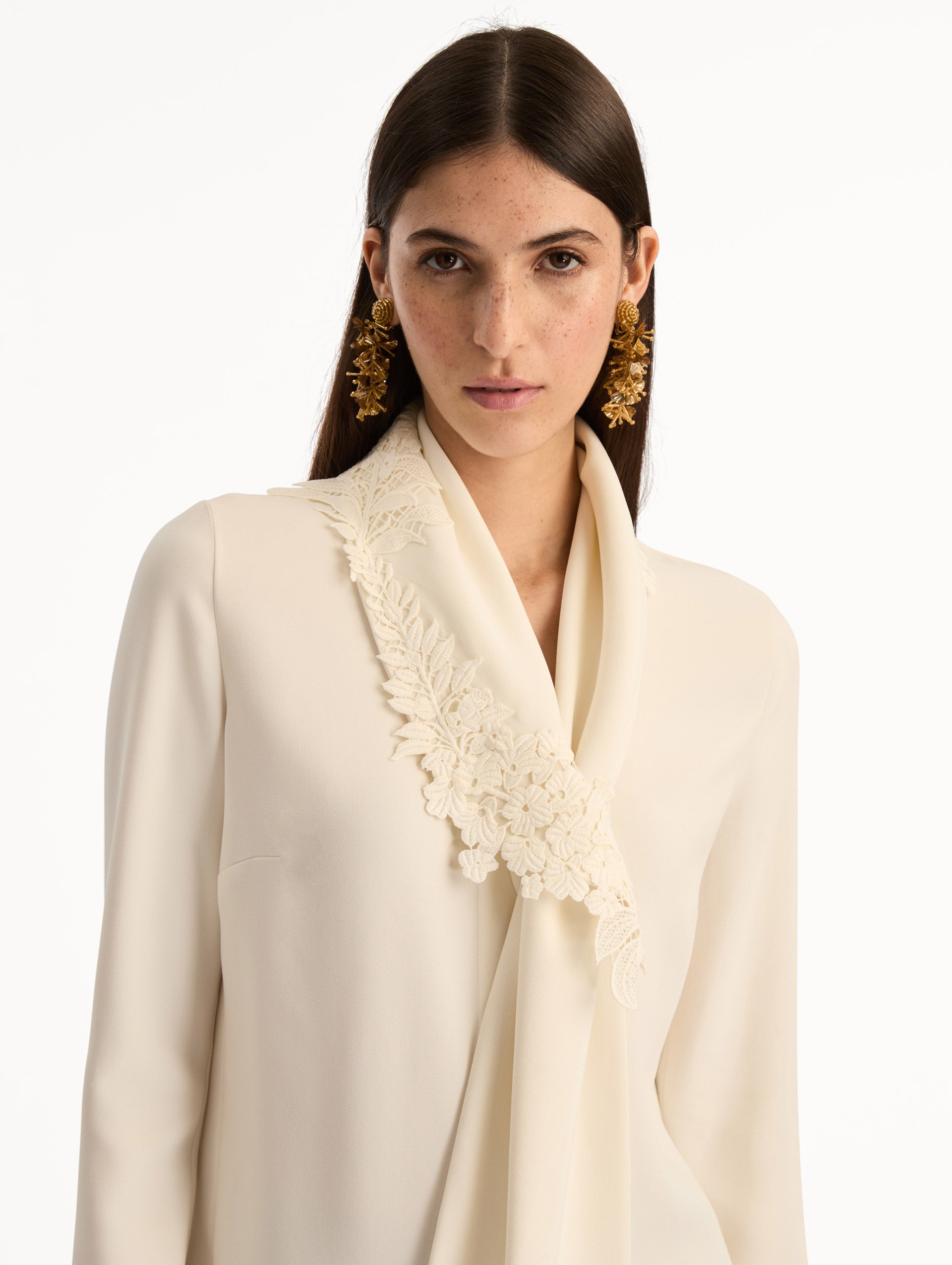 Ivory Foxglove Tie-Neck Georgette Blouse featuring a floral applique and long sleeves. Zoom View. 
