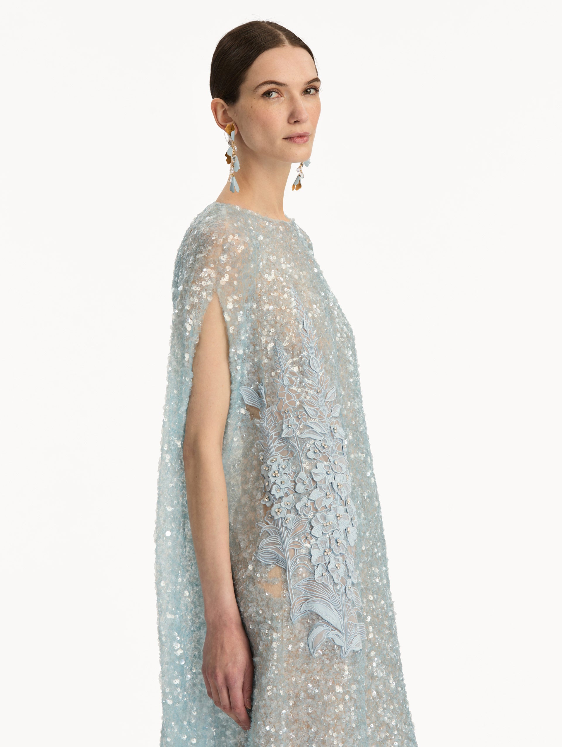 Light Blue Foxglove Embroidered Sequin Tulle Caftan with long caped sleeves and embroidered floral motifs. Zoom View.