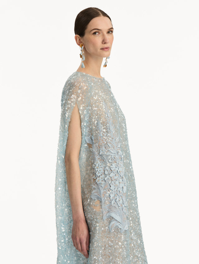 Light Blue Foxglove Embroidered Sequin Tulle Caftan with long caped sleeves and embroidered floral motifs. Zoom View.