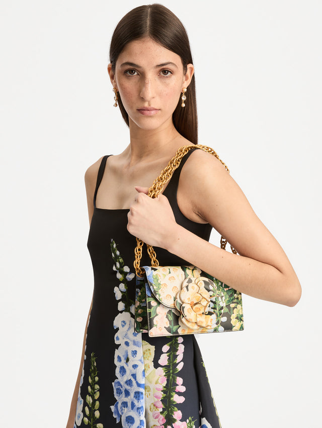 Floral Foxglove Printed TRO Bag with gold Hardware and Flower detail. Side View.