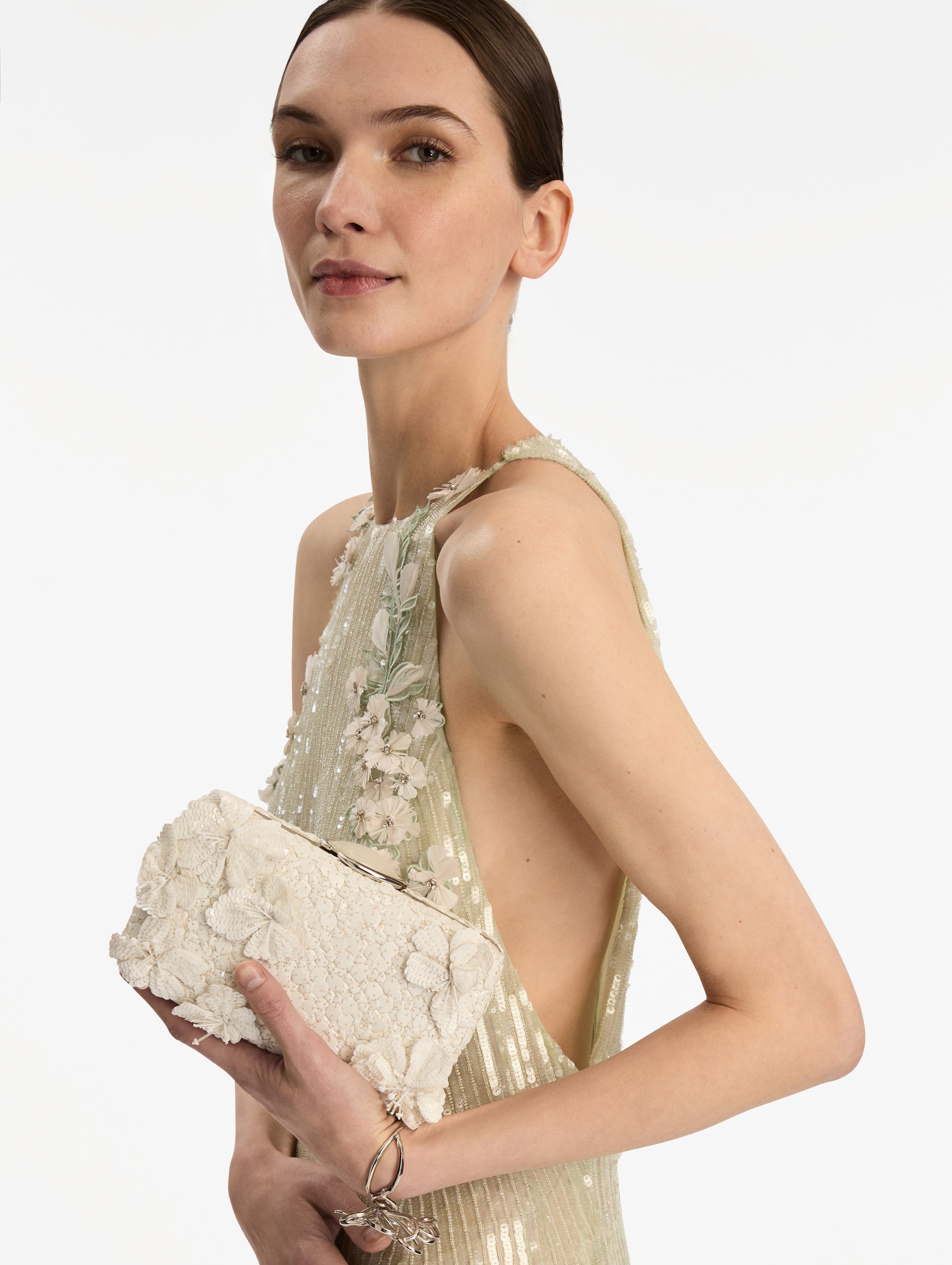 White Cherry Blossom Embroidered O Minaudière featuring a rectangular silhouette, beaded surface, and oversized three-dimensional flower embellishments. Side View.