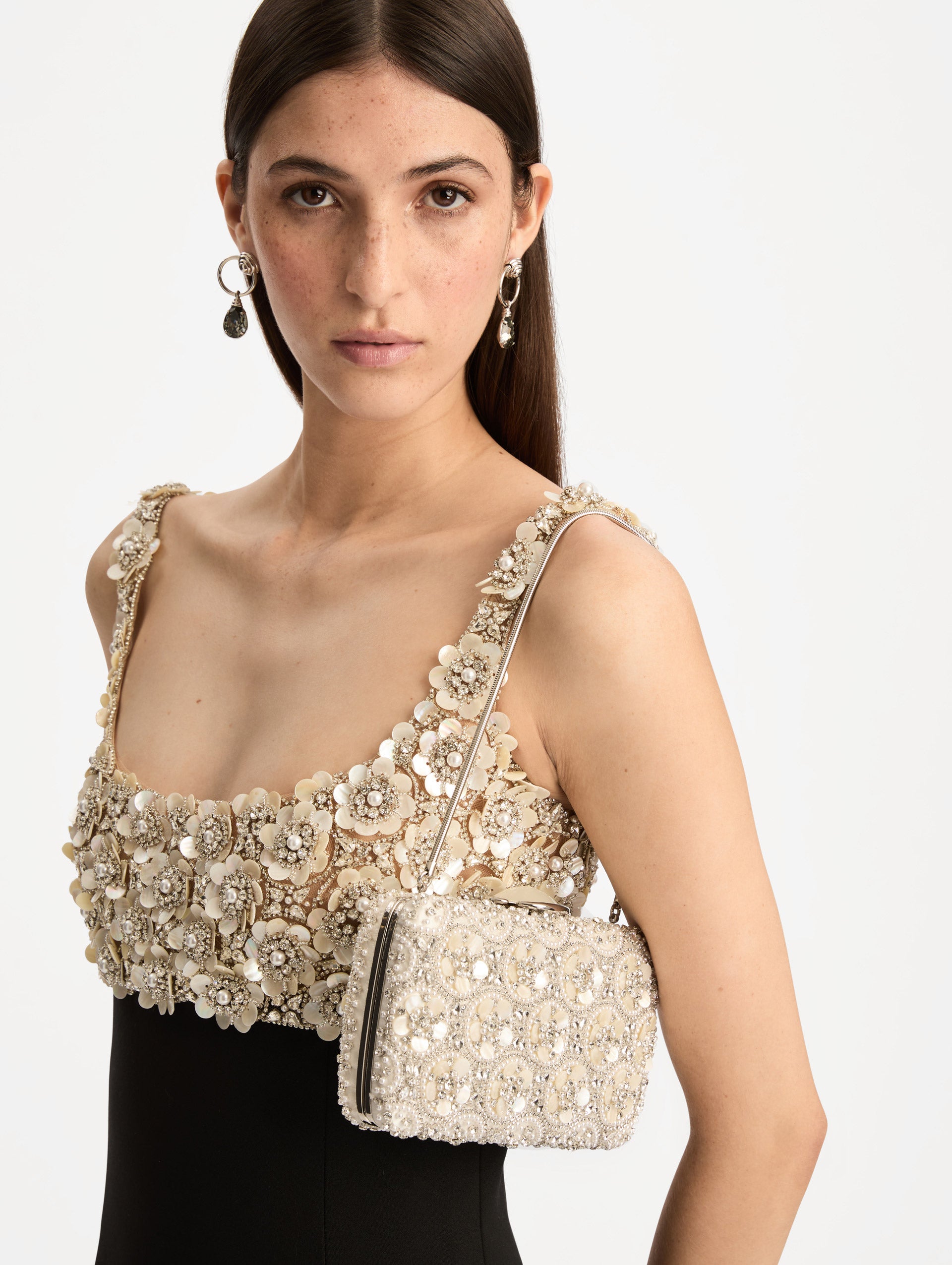 Ivory Mother of Pearl Embroidered O Minaudière featuring ivory beaded flowers, crystal detailing, and a structured rectangular silhouette with top clasp closure. Front View.