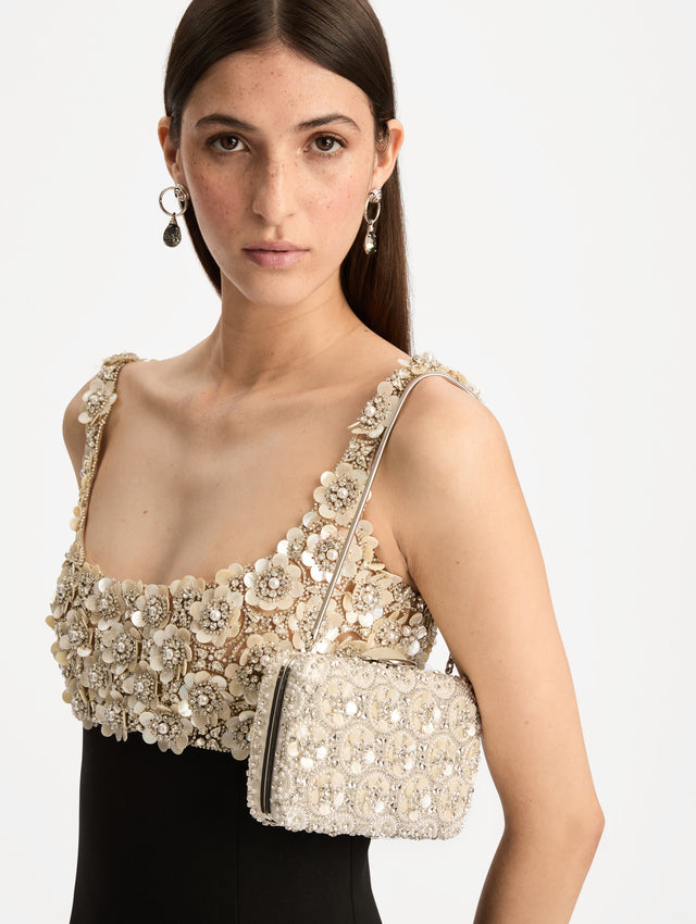 Ivory Mother of Pearl Embroidered O Minaudière featuring ivory beaded flowers, crystal detailing, and a structured rectangular silhouette with top clasp closure. Front View.