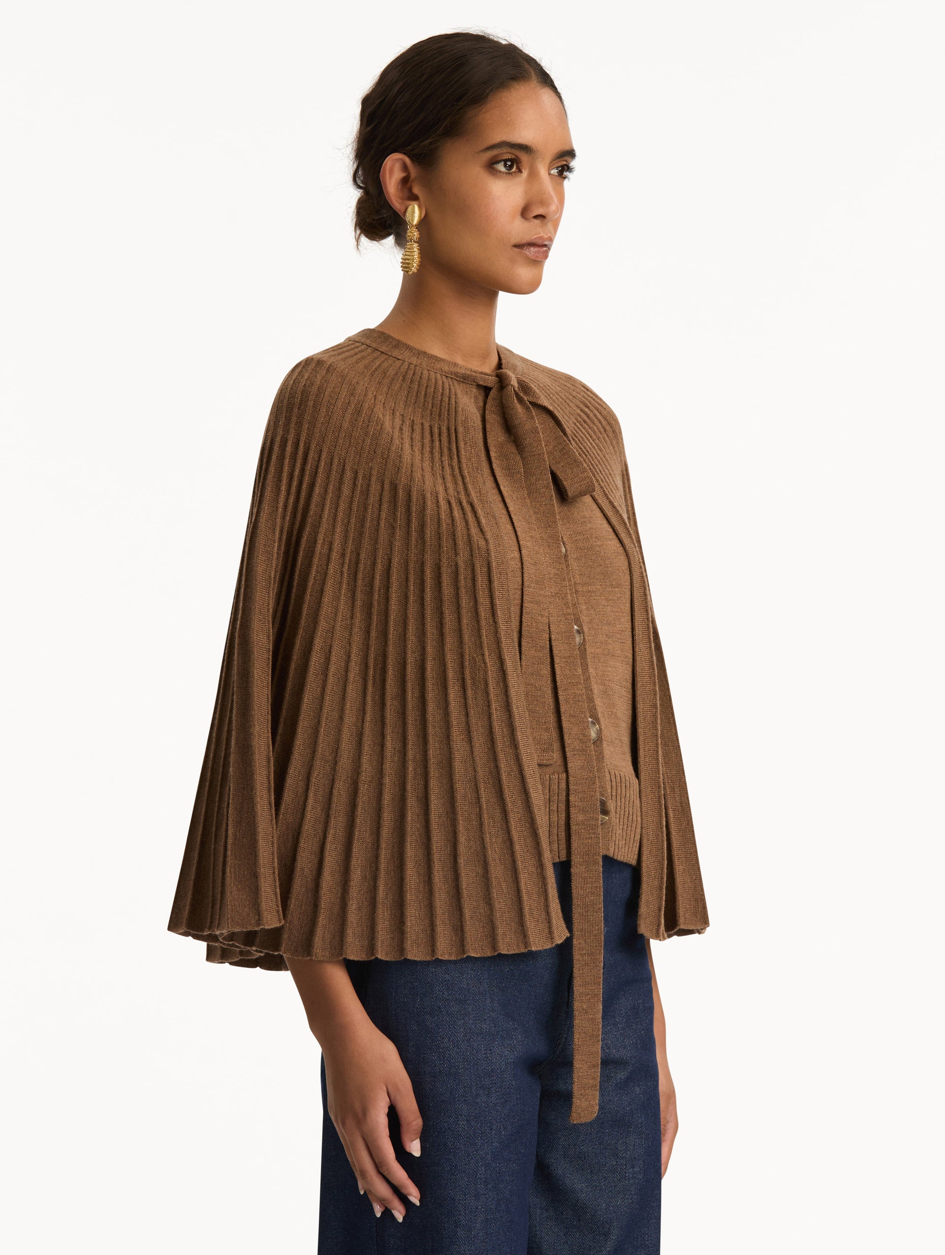 Brown Knit Capelet featuring a tie-neck closure, button front, and cropped silhouette. Side View.