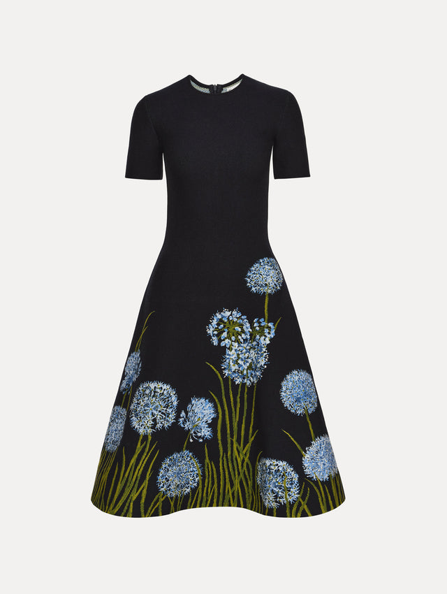 Navy Allium Jacquard Knit Dress featuring blue floral embroidery with green stem detailing along the skirt.