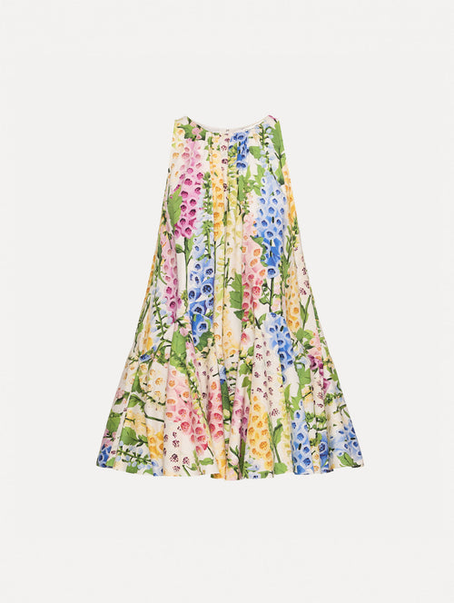 White and Floral Foxglove Cotton Poplin Trapeze Dress with a flowing pleated silhouette and round neckline.