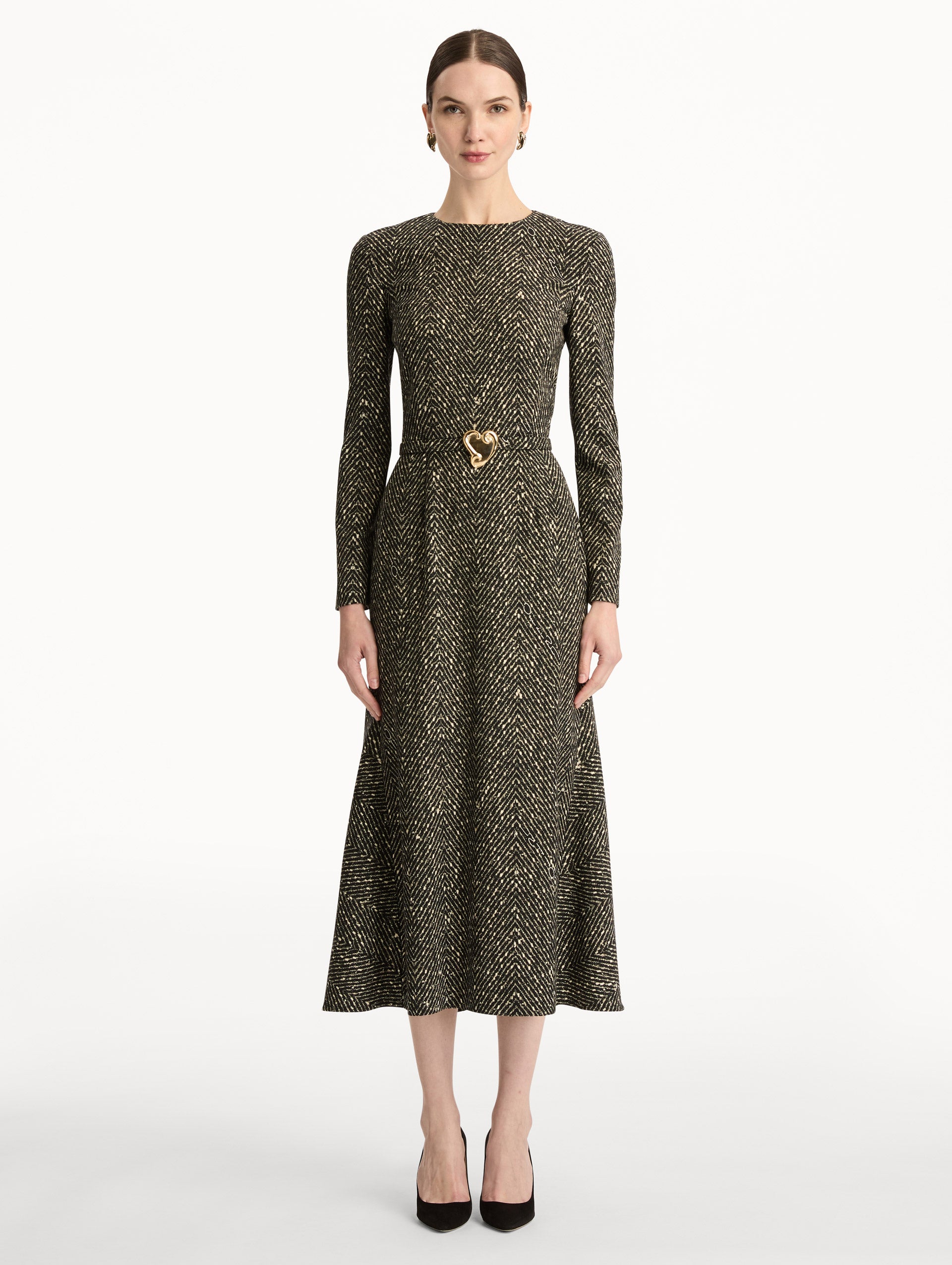 Black and Ivory Chevron Wool Dress featuring long-sleeves and a fitted waist with a sculptural gold heart accent. Front View.