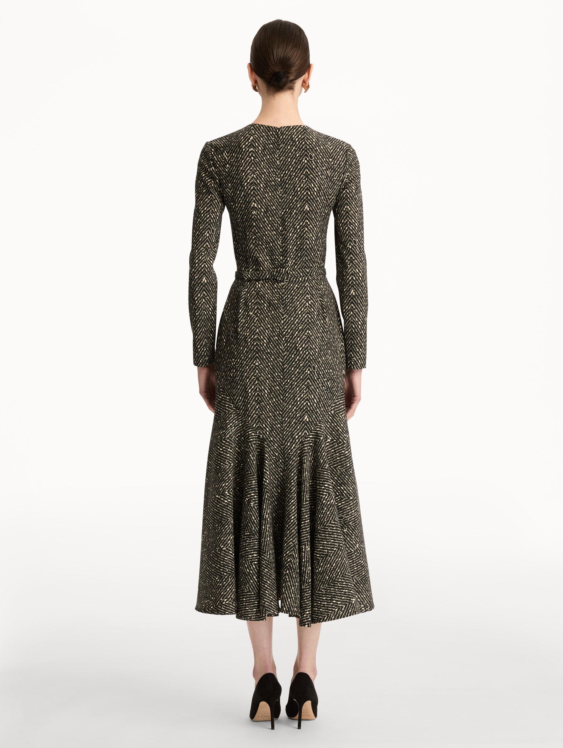 Black and Ivory Chevron Wool Dress featuring long-sleeves and a fitted waist with a sculptural gold heart accent. Back View.