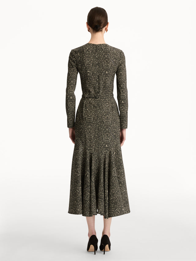 Black and Ivory Chevron Wool Dress featuring long-sleeves and a fitted waist with a sculptural gold heart accent. Back View.