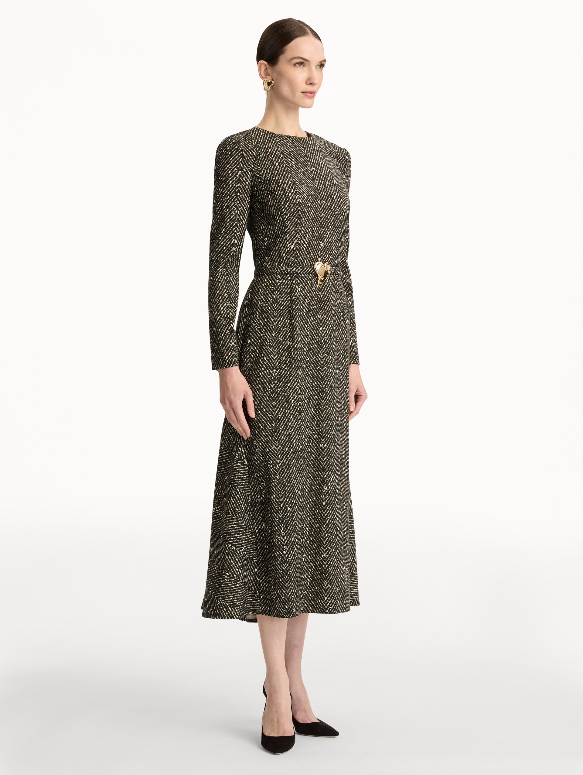 Black and Ivory Chevron Wool Dress featuring long-sleeves and a fitted waist with a sculptural gold heart accent. Side View.