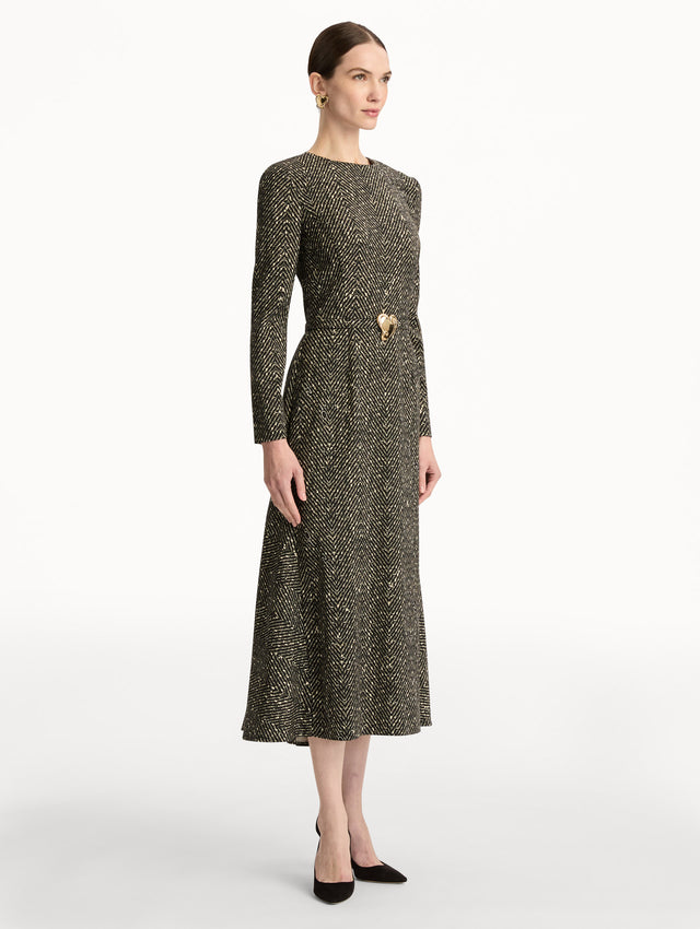 Black and Ivory Chevron Wool Dress featuring long-sleeves and a fitted waist with a sculptural gold heart accent. Side View.