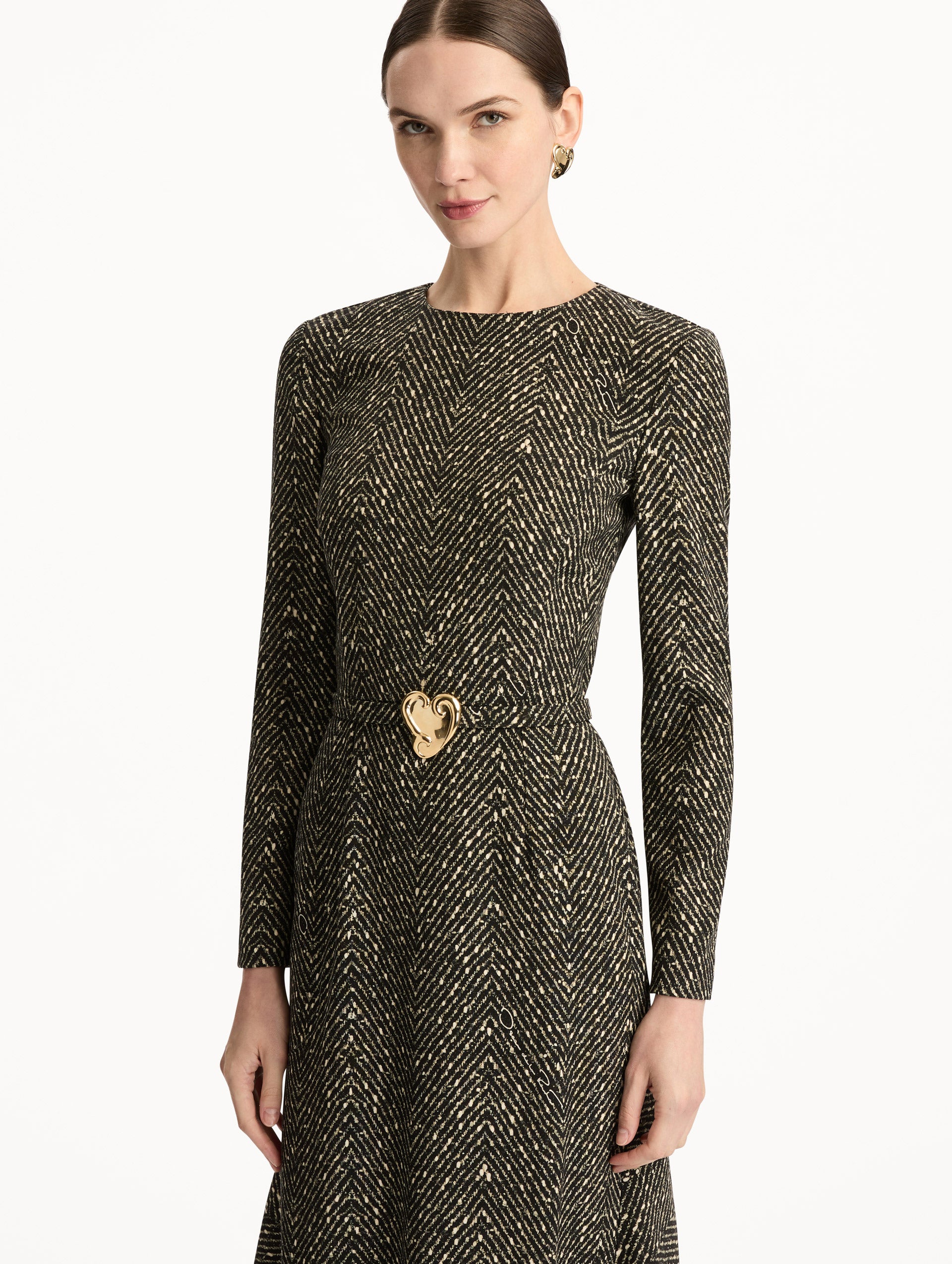Black and Ivory Chevron Wool Dress featuring long-sleeves and a fitted waist with a sculptural gold heart accent. Zoom View.
