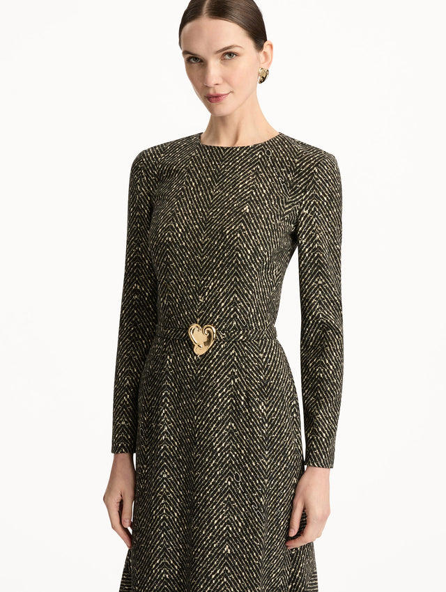 Black and Ivory Chevron Wool Dress featuring long-sleeves and a fitted waist with a sculptural gold heart accent. Zoom View.
