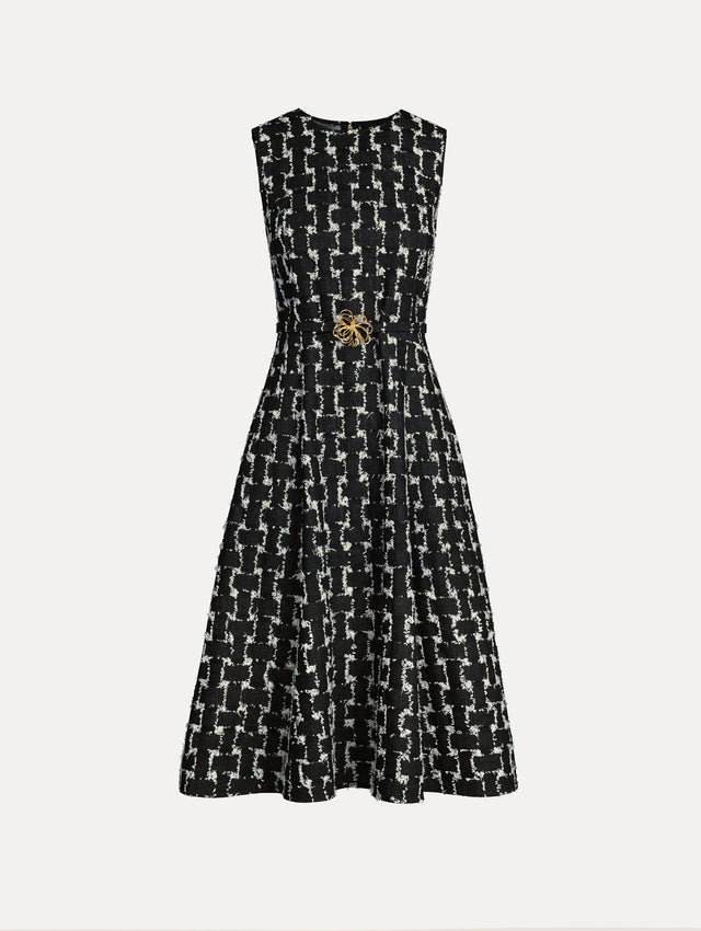 Black and Ivory Woven Denim Jacquard Midi Dress featuring a pleated skirt and belted waist with gold flower detail. Front View.