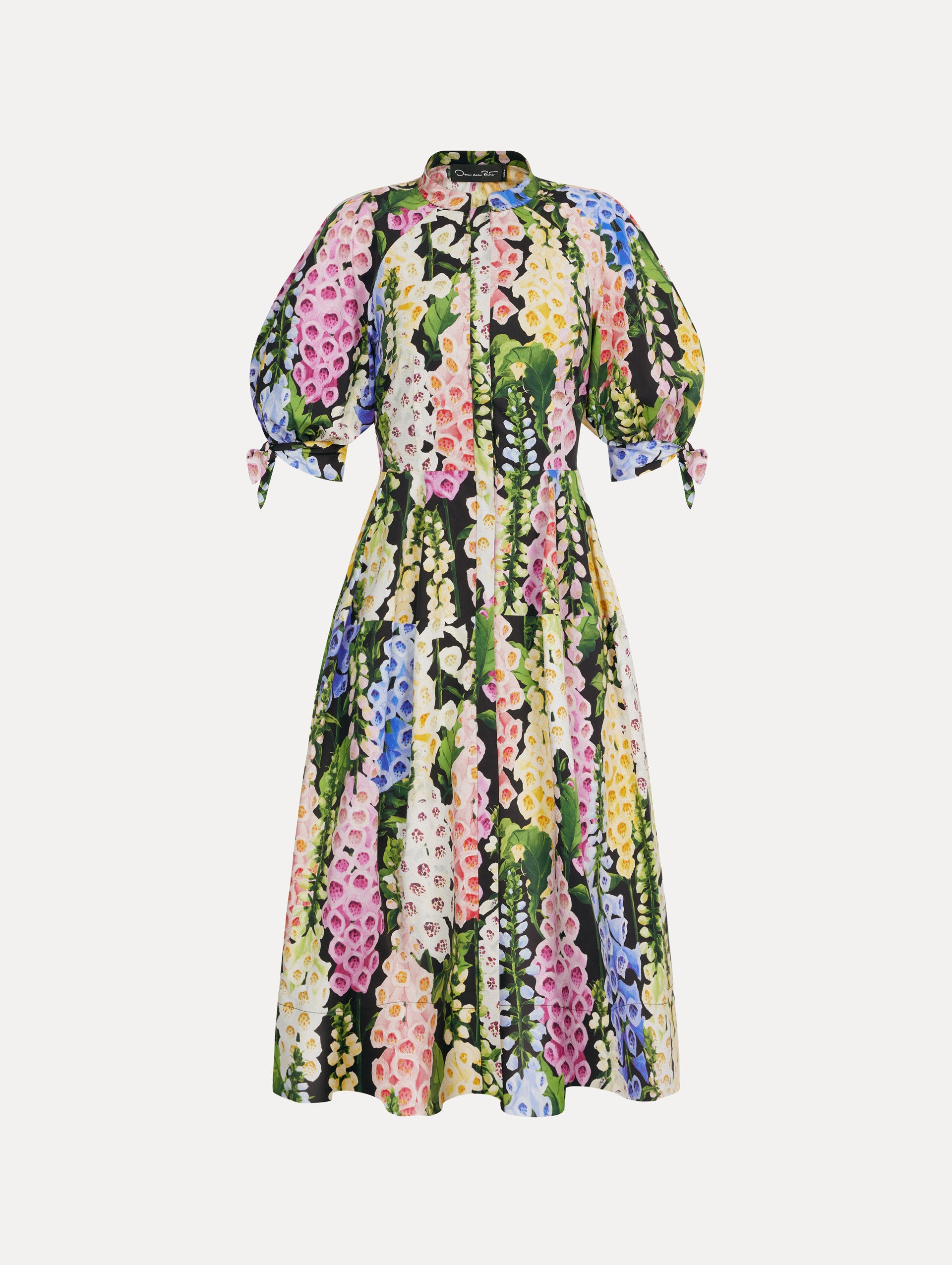 Black floral Foxglove Cotton Poplin Puff Sleeve Dress with voluminous elbow-length puff sleeves, a fitted waist, and a flared skirt that falls below the knee. Front View.