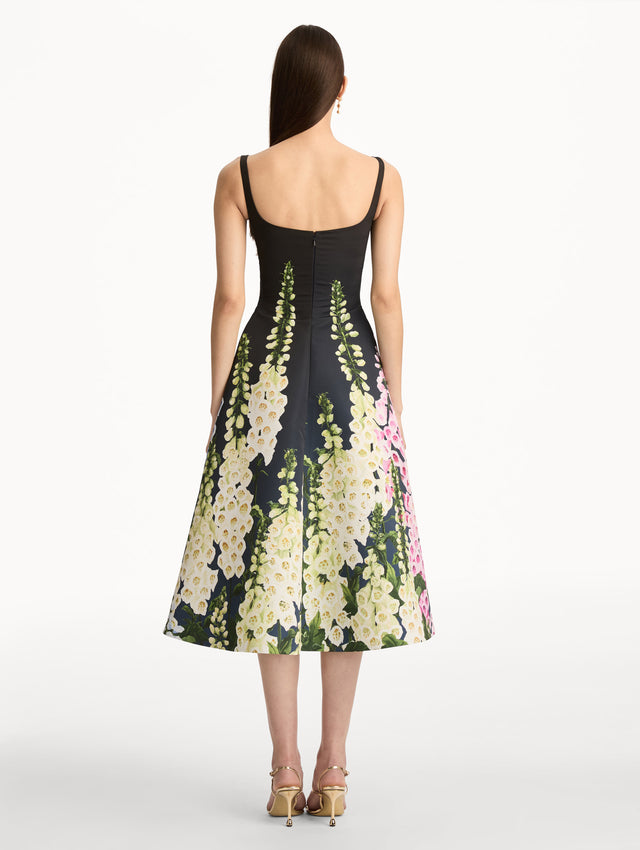 Black Degradé Foxglove Faille Dress featuring a fitted bodice, scoop neckline, and a flared skirt with multicolor foxglove floral print. Back View.