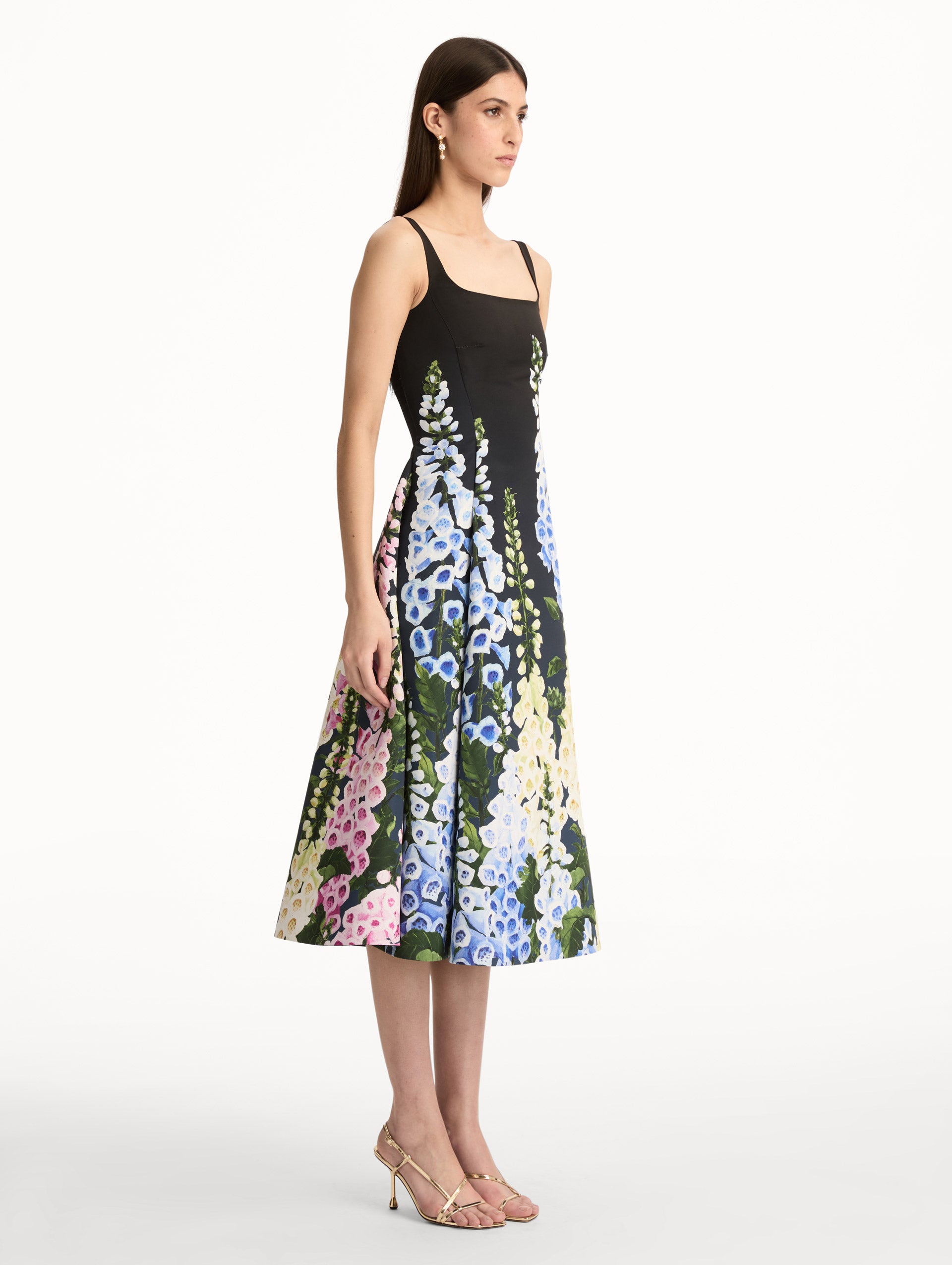 Black Degradé Foxglove Faille Dress featuring a fitted bodice, scoop neckline, and a flared skirt with multicolor foxglove floral print. Side View.