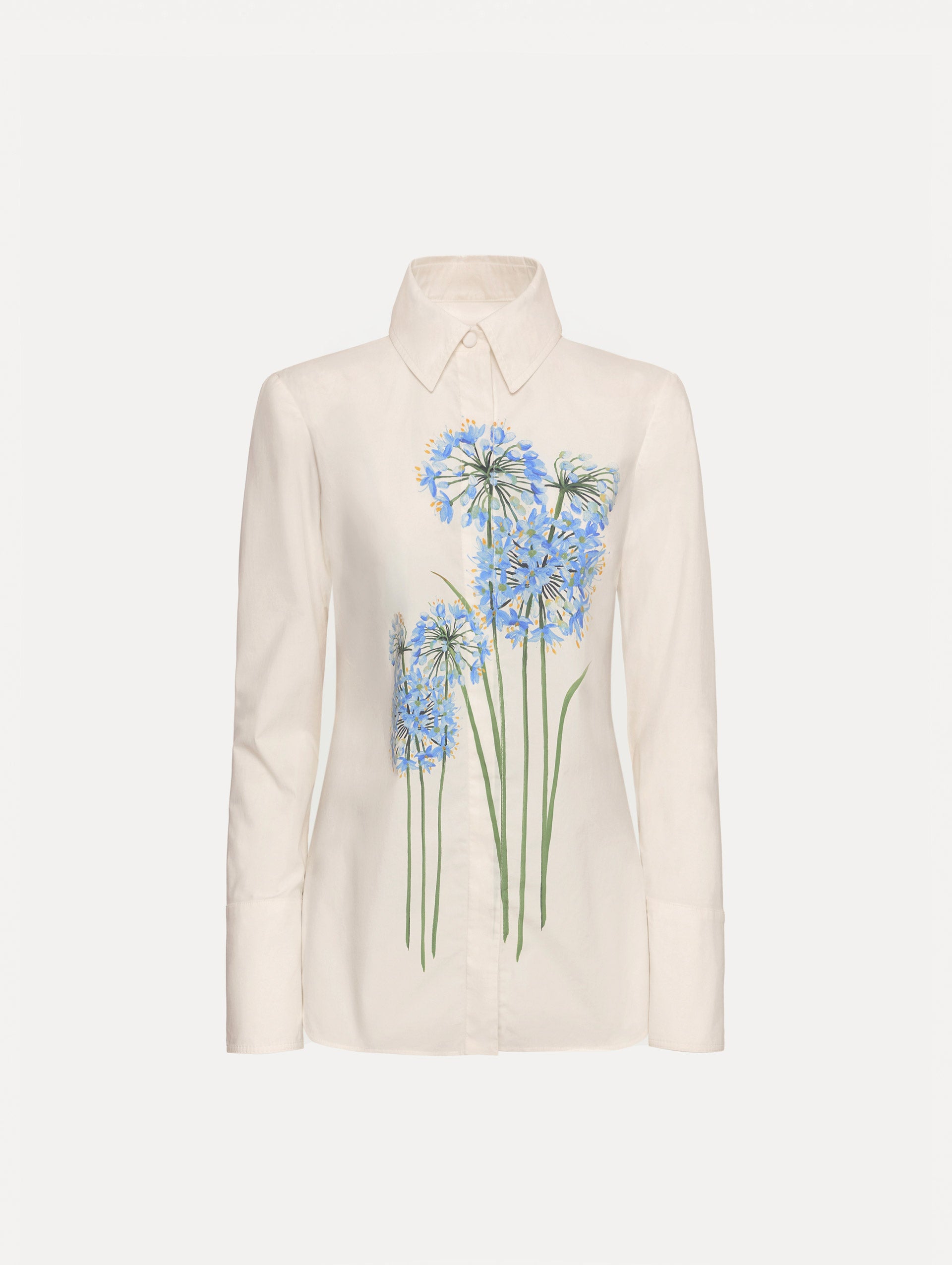 Ivory Allium Cotton Poplin Blouse with long sleeves and blue floral embroidery on the front.