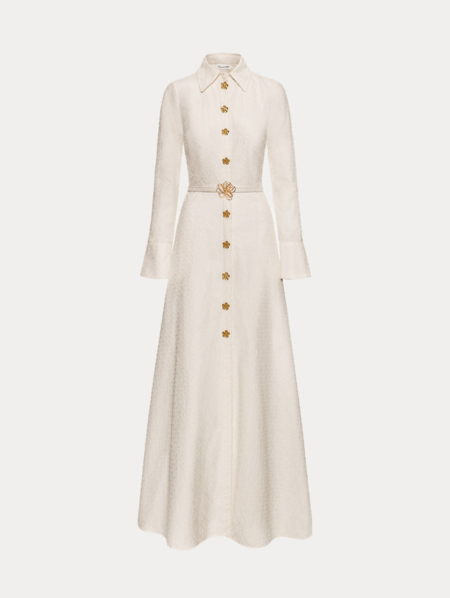 Ivory Oscar Chain-Link Cotton Poplin Caftan featuring a collared neckline, flared sleeves, gold button front, and belted waist with floral buckle.