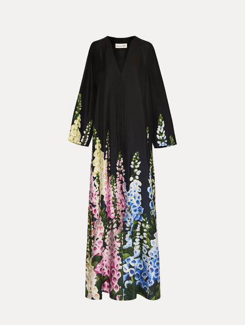 Black Degradé Foxglove Silk Twill Caftan with long sleeves, decorated with multicolor foxglove floral prints along the hem and sleeve edges.
