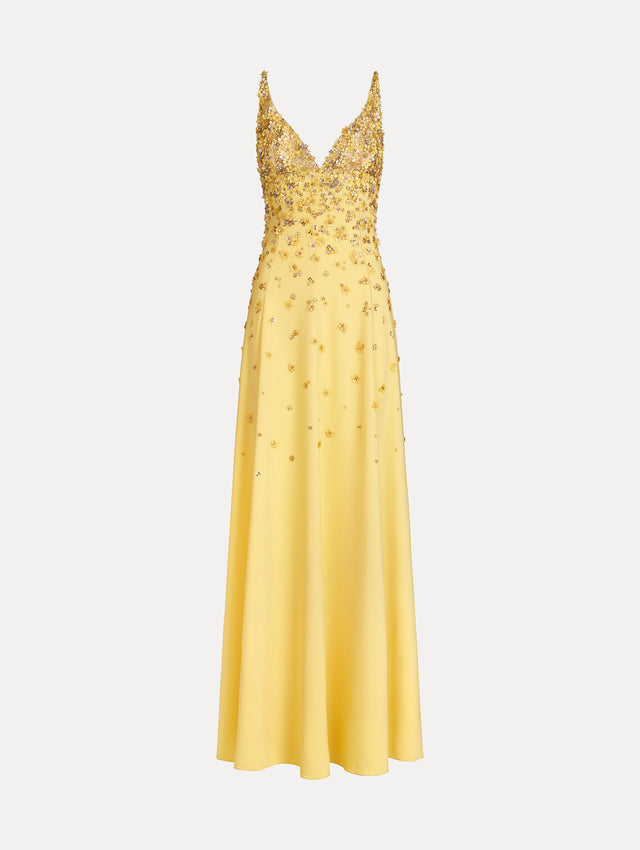 Sleeveless, open back, Yellow v-neck gown with porcelain-flower motifs rendered in sequins and crystals along neckline and bodice, tapering into the skirt. Front View. 