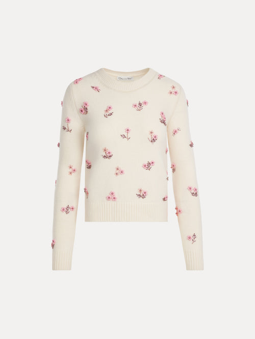 Crew neck, long sleeve sweater with pink floral embellishments. Front View.