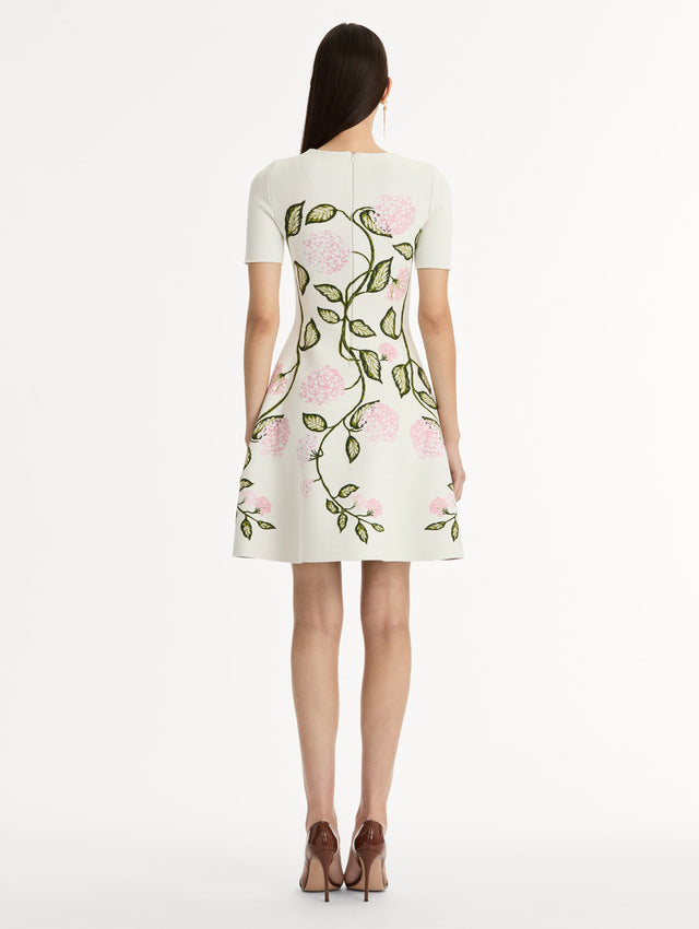 Ivory Jacquard knit dress with porcelain flower print along silhouette. Short Sleeve Mini Dress. Back View. 