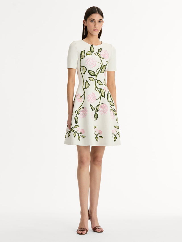 Ivory Jacquard knit dress with porcelain flower print along silhouette. Short Sleeve Mini Dress. Side View. 