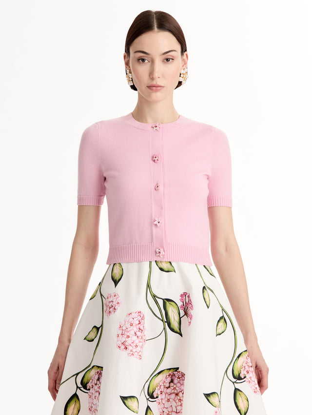 Light pink cropped cardigan, Floral Button closure, short sleeves. Front View