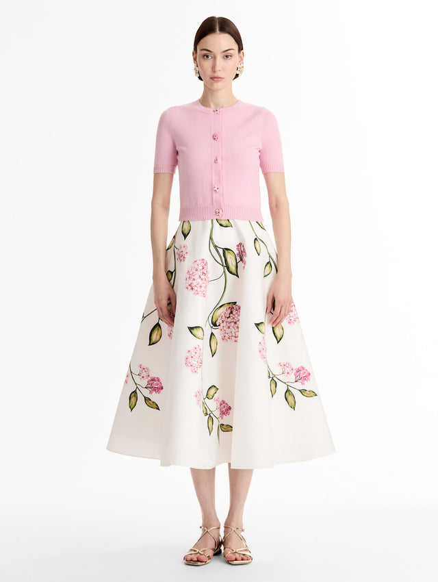 Light pink cropped cardigan, Floral Button closure, short sleeves. Front View