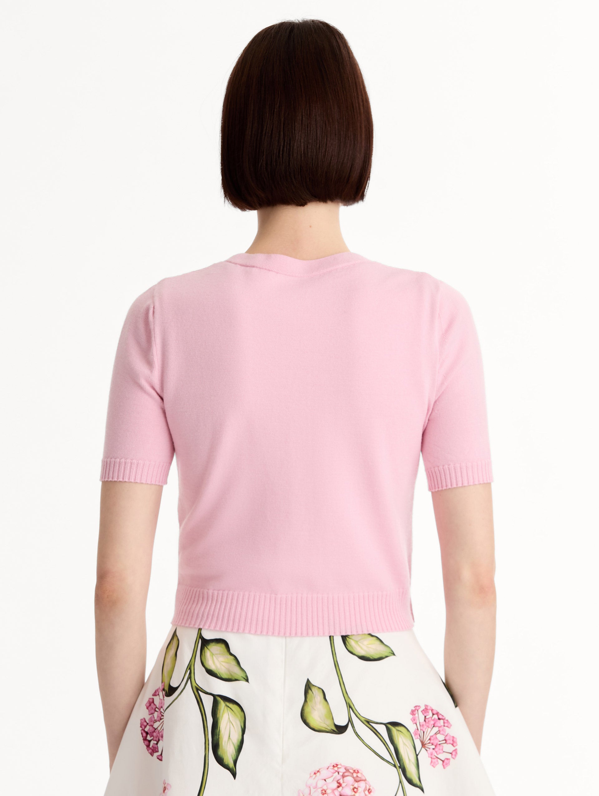 Light pink cropped cardigan, Floral Button closure, short sleeves. Back View