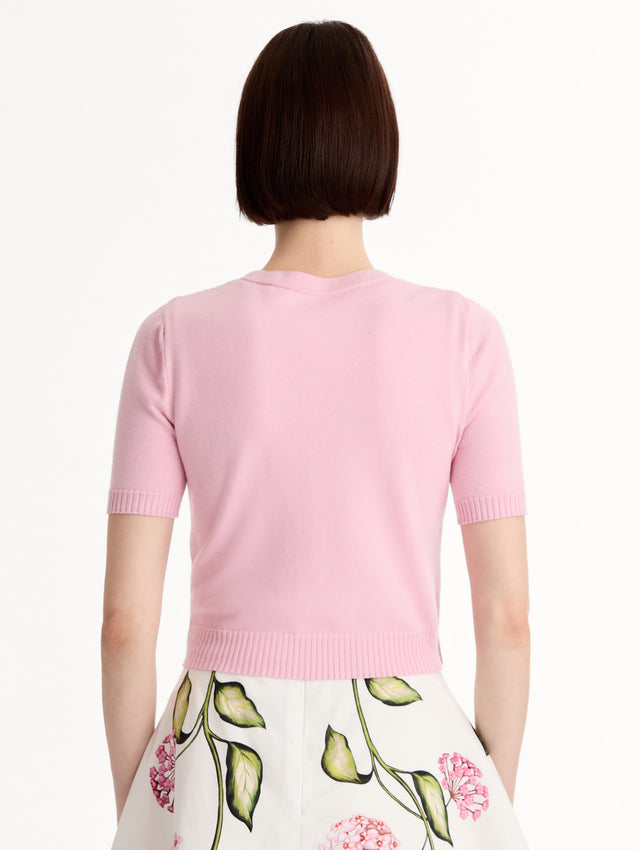 Light pink cropped cardigan, Floral Button closure, short sleeves. Back View