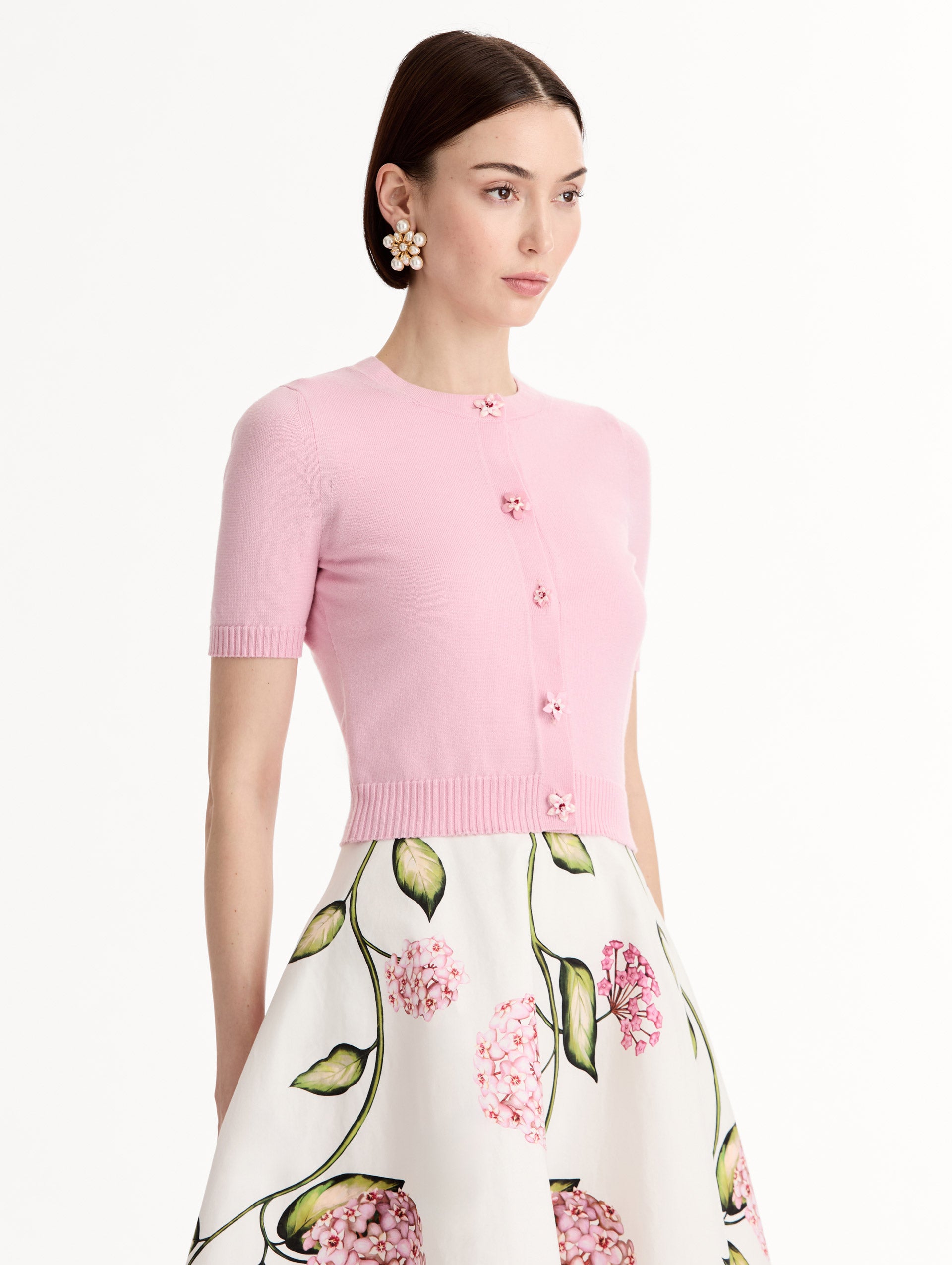 Light pink cropped cardigan, Floral Button closure, short sleeves. Side View