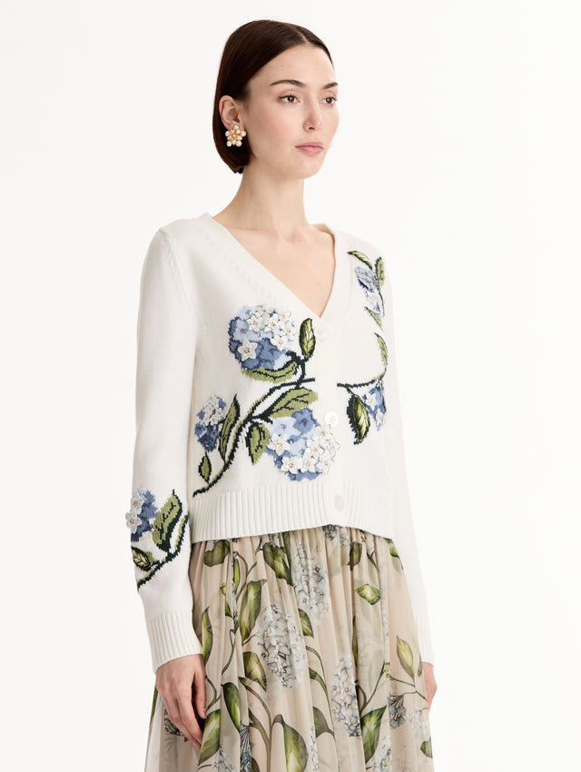 White Porcelain Flower Jacquard Cardigan featuring a V-Neckline and blue and green floral print. Side View.