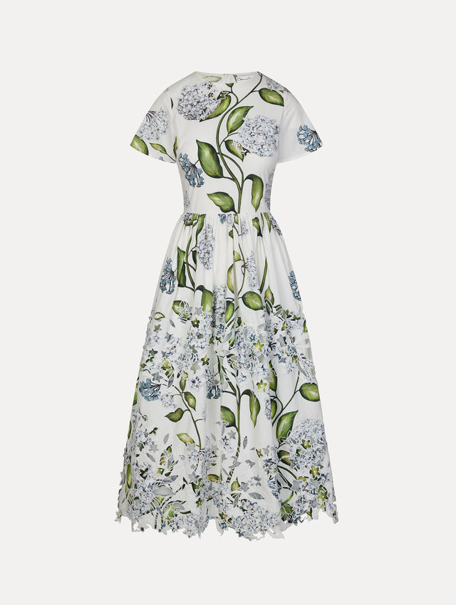 Ivory and floral Porcelain Flower Embroidered Cotton Poplin Dress with belted waist, short sleeves, and floral cutout embroidery. Front View.