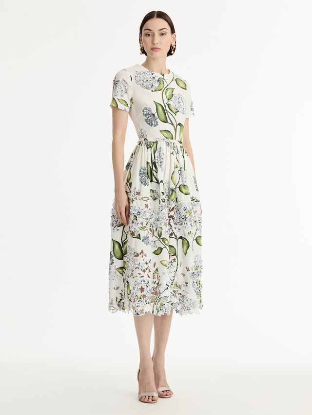 Ivory and floral Porcelain Flower Embroidered Cotton Poplin Dress with belted waist, short sleeves, and floral cutout embroidery. Side View.