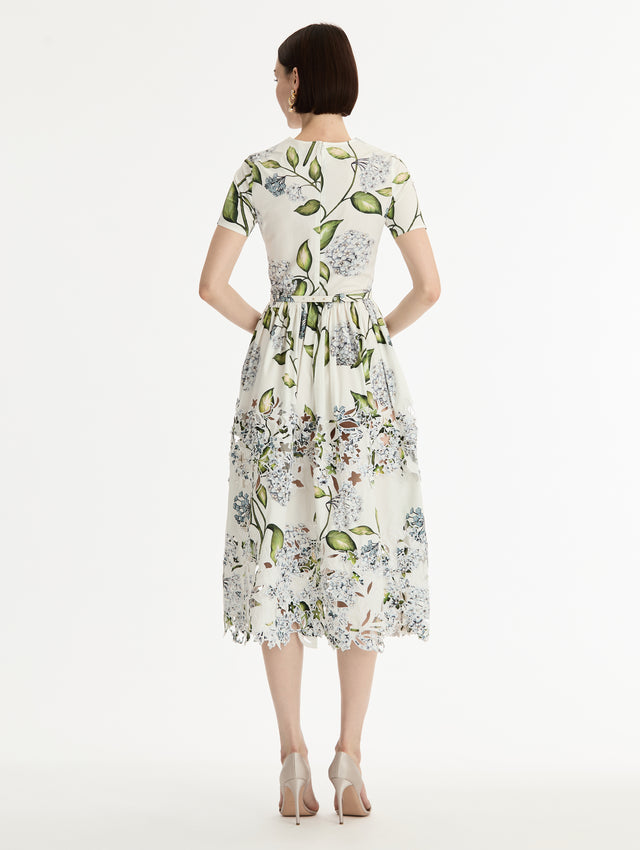 Ivory and floral Porcelain Flower Embroidered Cotton Poplin Dress with belted waist, short sleeves, and floral cutout embroidery. Back View.
