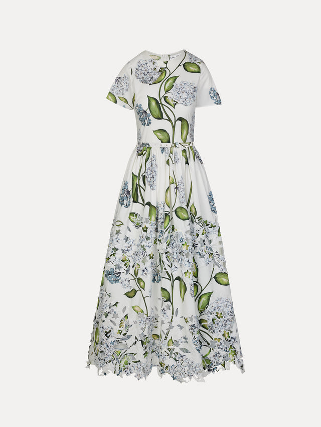 Ivory and floral Porcelain Flower Embroidered Cotton Poplin Dress with belted waist, short sleeves, and floral cutout embroidery. Side View.