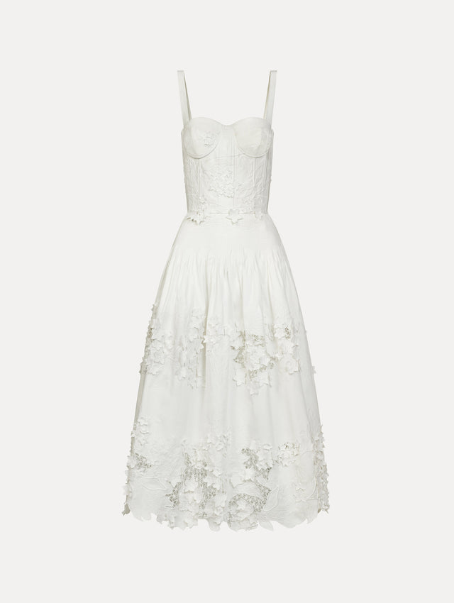 Cotton stretch twill dress. Sculpted bustier bodice with full, midi-length skirt.  porcelain-flower guipure lace along hem. Three-dimensional floral appliqués in layered white-on-white texture. Front View.