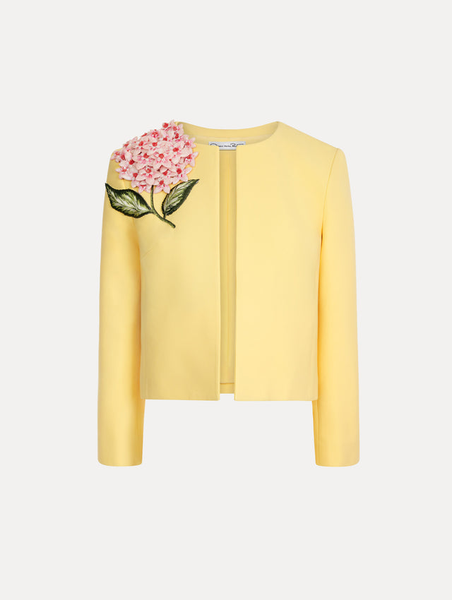 Structured jacket in the color Butter Yellow with 3-dimensional flower detail at shoulder.