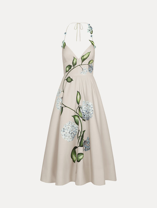 Dress in the colors White and Denim Blue with delicate halter V-neck, flowy skirt, and flower motif.