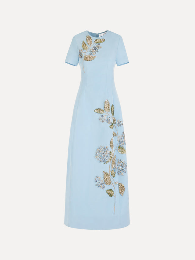 The Crystal Flower Embroidered Faille Dress in the color light blue with short sleeves, a sculpted skirt, and crystal-embroidered floral motifs.