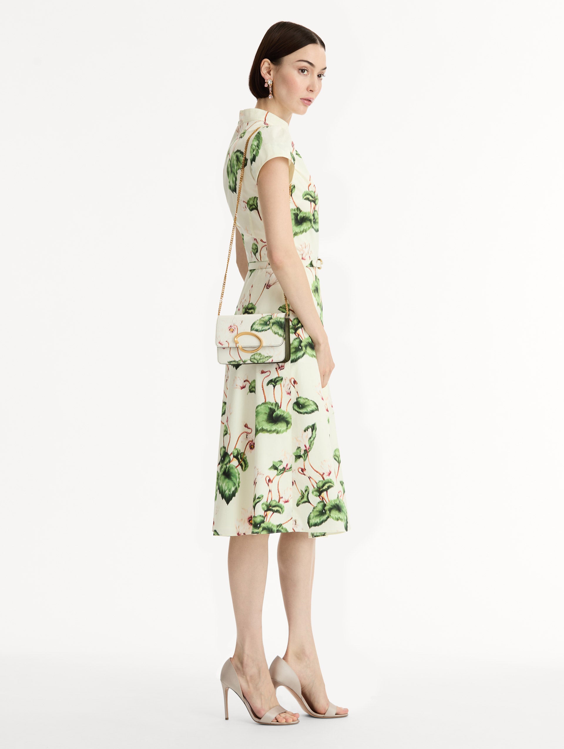 Ivory Cyclamen-Printed O Pochette with green and pink floral motifs and gold hardware. Front View.