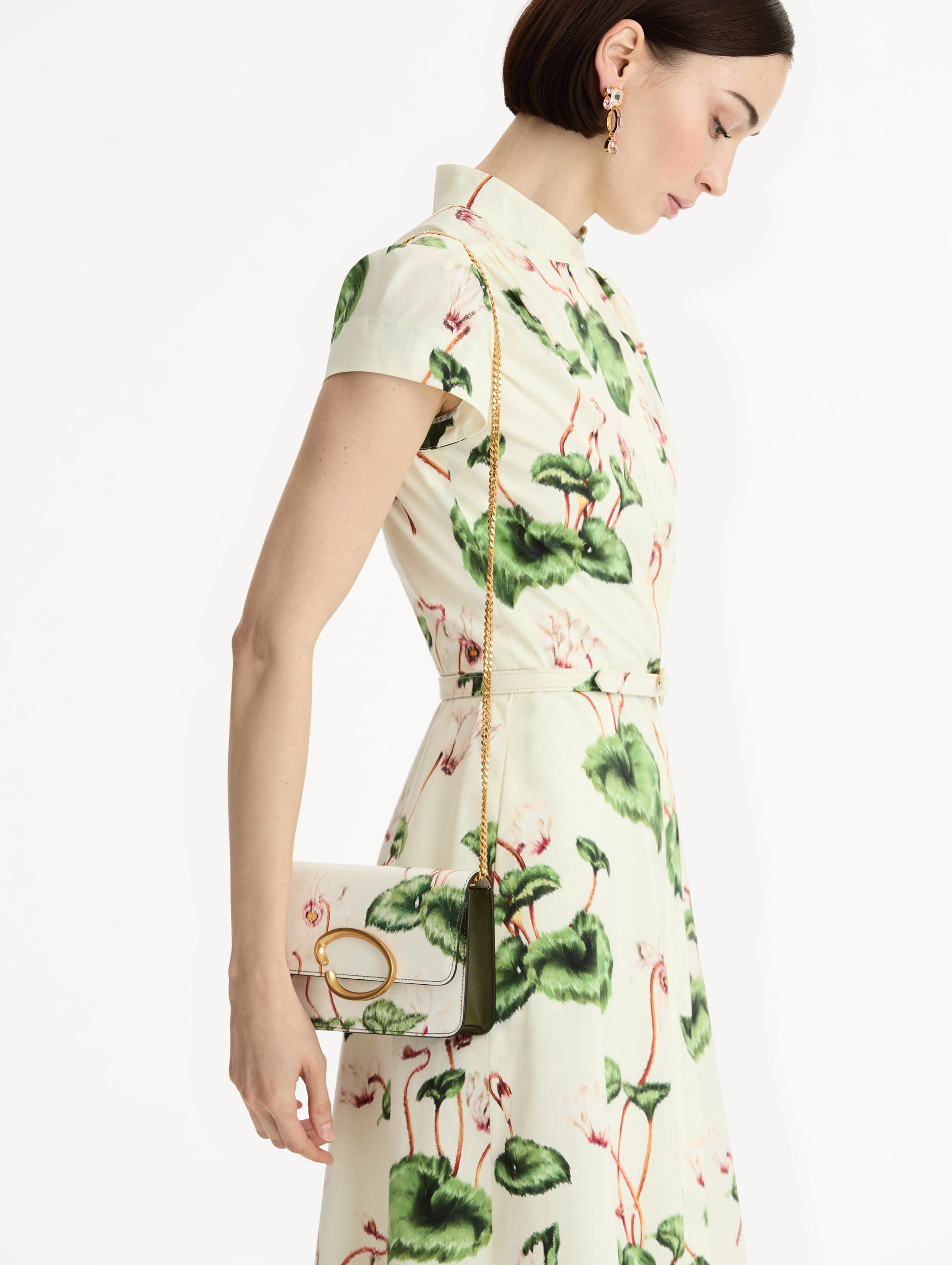 Ivory Cyclamen-Printed O Pochette with green and pink floral motifs and gold hardware. Front View.