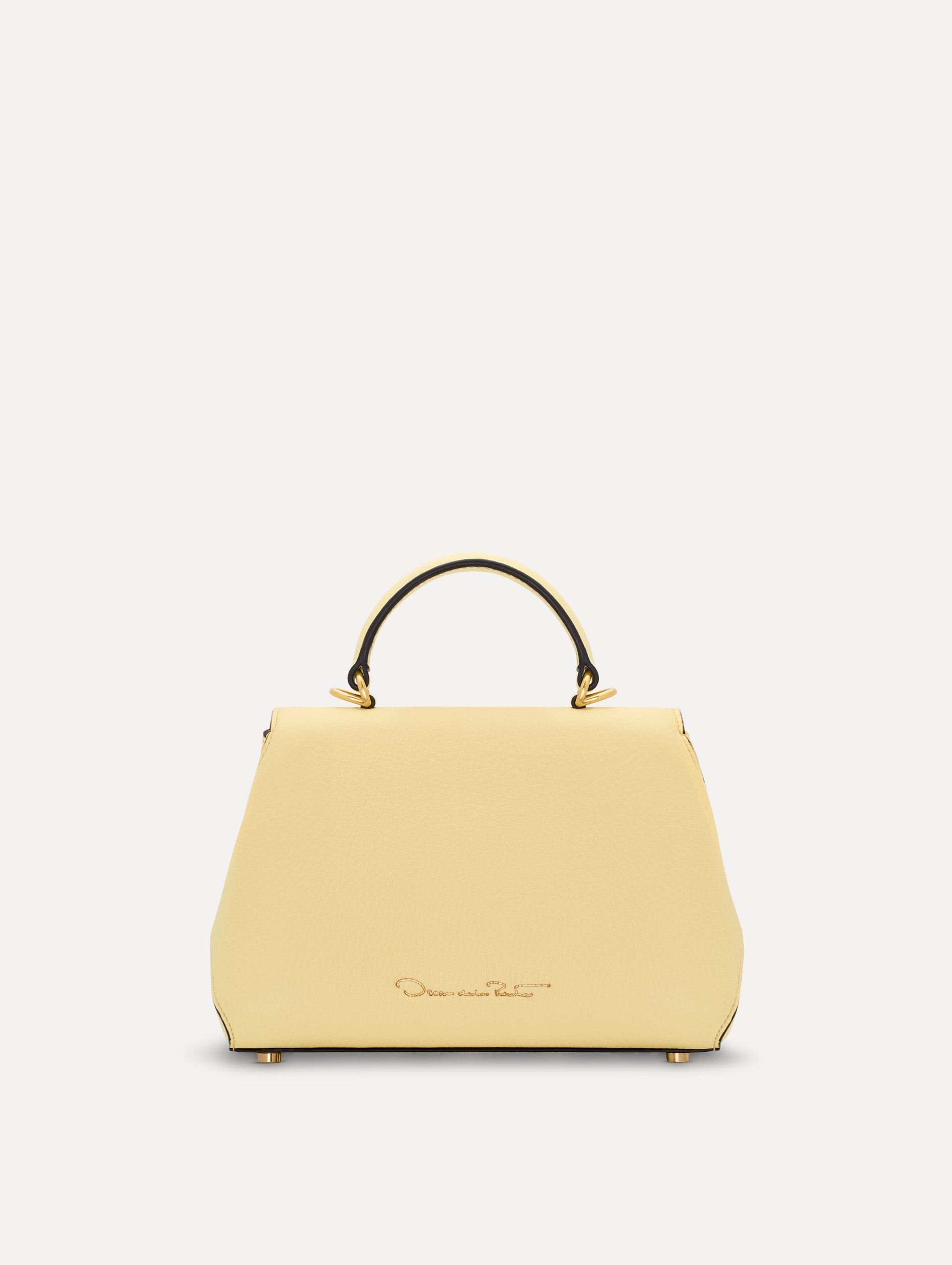 The Mini Poppy in yellow with floral cutout designs and gold hardware. Back View. 