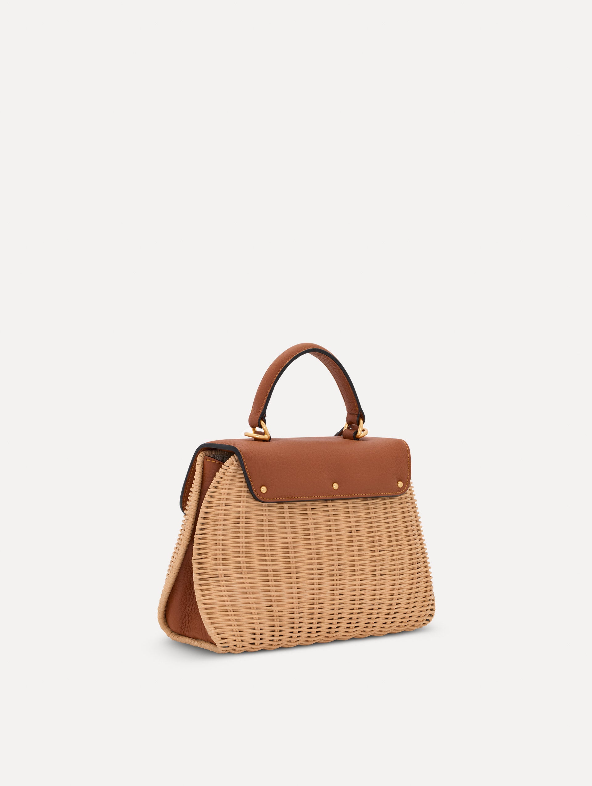 The Mini Poppy in Wicker in brown. Side view.