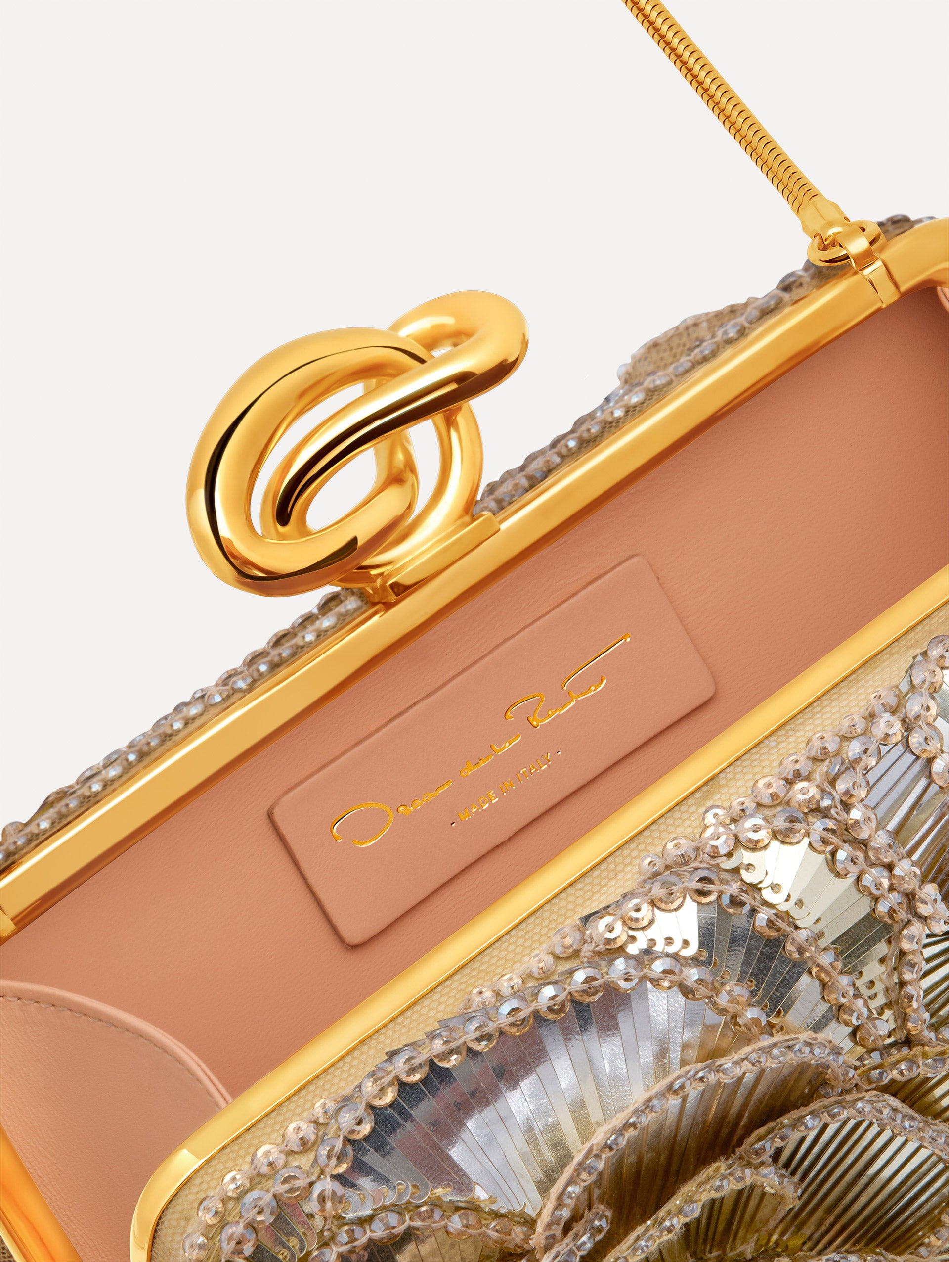 Silver Crystal Pavé Knot Minaudière with gold hardware and an O motif clasp.  Zoom View.